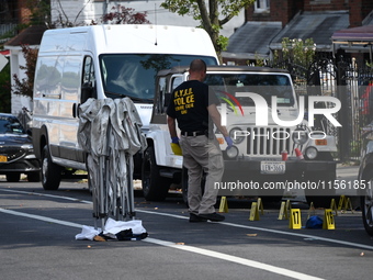 Crime scene investigators investigate the scene, place evidence markers, and search for clues after a 46-year-old male is shot multiple time...