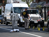 Crime scene investigators investigate the scene, place evidence markers, and search for clues after a 46-year-old male is shot multiple time...