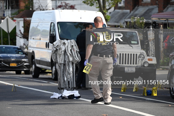 Crime scene investigators investigate the scene, place evidence markers, and search for clues after a 46-year-old male is shot multiple time...