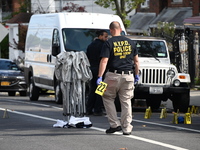 Crime scene investigators investigate the scene, place evidence markers, and search for clues after a 46-year-old male is shot multiple time...