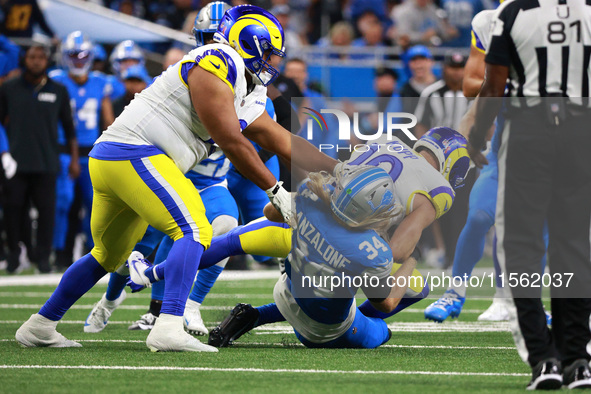 DETROIT,MICHIGAN-SEPTEMBER 8: Los Angeles Rams wide receiver Cooper Kupp (10) is tackled by Detroit Lions linebacker Alex Anzalone (34) duri...