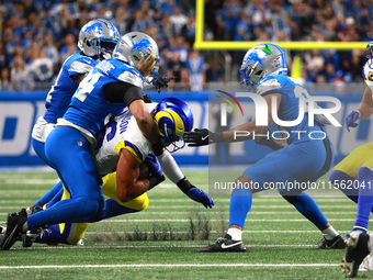 DETROIT,MICHIGAN-SEPTEMBER 8: Los Angeles Rams tight end Colby Parkinson (86) is tackled by Detroit Lions linebacker Alex Anzalone (34) duri...