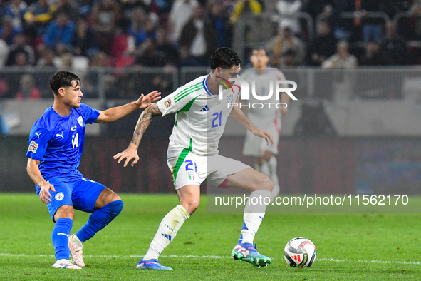 Alessandro Bastoni and Gavriel Kanichowsky are in action during Israel vs Italy: matchday 2 of UEFA Nations League 2024-2025, in Budapest, H...