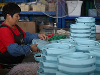 Workers assemble pet cat toys at a workshop in Suqian, Jiangsu province, China, on September 10, 2024. (