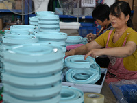 Workers assemble pet cat toys at a workshop in Suqian, Jiangsu province, China, on September 10, 2024. (