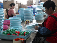 Workers assemble pet cat toys at a workshop in Suqian, Jiangsu province, China, on September 10, 2024. (