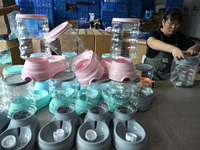 A worker assembles a pet water dispenser at a workshop in Suqian, China, on September 10, 2024. (