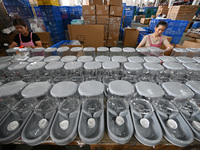 A worker assembles a pet water dispenser at a workshop in Suqian, China, on September 10, 2024. (