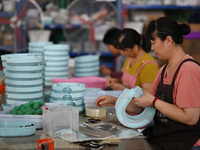 Workers assemble pet cat toys at a workshop in Suqian, Jiangsu province, China, on September 10, 2024. (