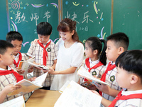 Han Jianrui, a primary school teacher, accompanies her students to read in Zaozhuang, China, on September 10, 2024. (