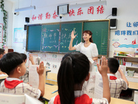 Han Jianrui, a primary school teacher, interacts with students during a ''Teachers' Day themed class meeting'' in Zaozhuang, China, on Septe...