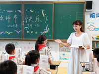 Han Jianrui, a primary school teacher, interacts with students during a ''Teachers' Day themed class meeting'' in Zaozhuang, China, on Septe...