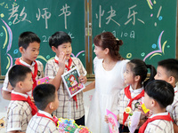 Children present handicrafts made by themselves to their teachers at Wenhua Road Primary School in Zaozhuang, China, on September 10, 2024....