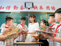 Han Jianrui, a primary school teacher, accompanies her students to read in Zaozhuang, China, on September 10, 2024. (