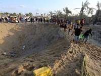 People inspect the site following Israeli strikes on a tent camp sheltering displaced people amid the Israel-Hamas conflict in the Al-Mawasi...