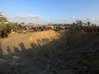 People inspect the site following Israeli strikes on a tent camp sheltering displaced people amid the Israel-Hamas conflict in the Al-Mawasi...