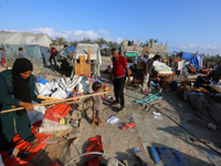 People inspect the site following Israeli strikes on a tent camp sheltering displaced people amid the Israel-Hamas conflict in the Al-Mawasi...