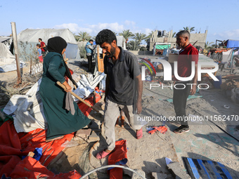 People inspect the site following Israeli strikes on a tent camp sheltering displaced people amid the Israel-Hamas conflict in the Al-Mawasi...