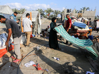 People inspect the site following Israeli strikes on a tent camp sheltering displaced people amid the Israel-Hamas conflict in the Al-Mawasi...