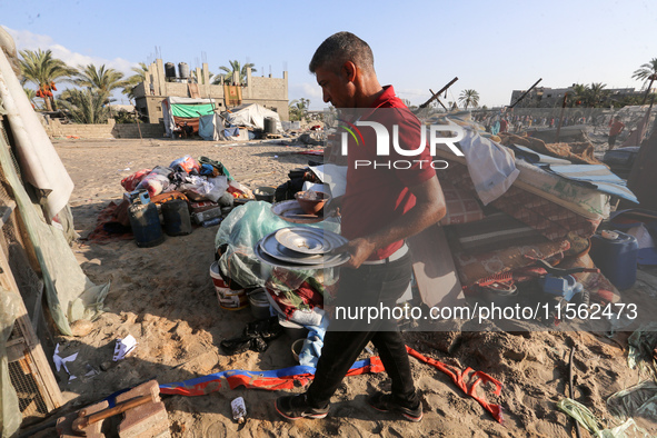 People inspect the site following Israeli strikes on a tent camp sheltering displaced people amid the Israel-Hamas conflict in the Al-Mawasi...