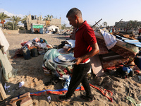 People inspect the site following Israeli strikes on a tent camp sheltering displaced people amid the Israel-Hamas conflict in the Al-Mawasi...