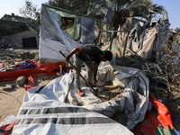 People inspect the site following Israeli strikes on a tent camp sheltering displaced people amid the Israel-Hamas conflict in the Al-Mawasi...