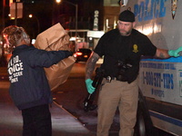 Crime scene investigators collect evidence, search for clues, and investigate the shooting death of 57-year-old Ying Zhu Liu, who is shot in...