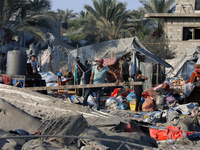 People inspect the site following Israeli strikes on a tent camp sheltering displaced people amid the Israel-Hamas conflict in the Al-Mawasi...