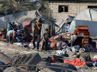 People inspect the site following Israeli strikes on a tent camp sheltering displaced people amid the Israel-Hamas conflict in the Al-Mawasi...