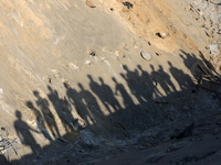 People inspect the site following Israeli strikes on a tent camp sheltering displaced people amid the Israel-Hamas conflict in the Al-Mawasi...