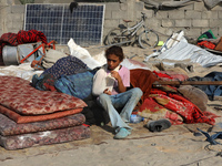 People inspect the site following Israeli strikes on a tent camp sheltering displaced people amid the Israel-Hamas conflict in the Al-Mawasi...