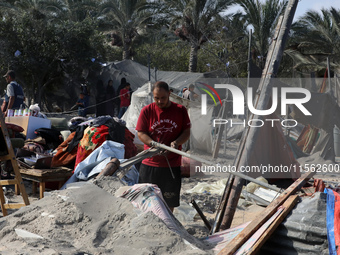 People inspect the site following Israeli strikes on a tent camp sheltering displaced people amid the Israel-Hamas conflict in the Al-Mawasi...