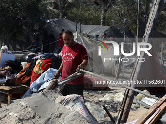 People inspect the site following Israeli strikes on a tent camp sheltering displaced people amid the Israel-Hamas conflict in the Al-Mawasi...