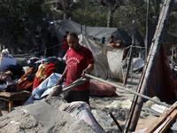 People inspect the site following Israeli strikes on a tent camp sheltering displaced people amid the Israel-Hamas conflict in the Al-Mawasi...