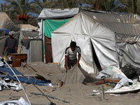 People inspect the site following Israeli strikes on a tent camp sheltering displaced people amid the Israel-Hamas conflict in the Al-Mawasi...