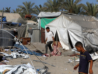 People inspect the site following Israeli strikes on a tent camp sheltering displaced people amid the Israel-Hamas conflict in the Al-Mawasi...