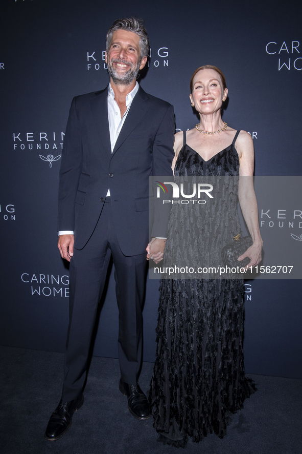 Bart Freundlich and Julianne Moore attend Kering's 3rd Annual Caring for Women Dinner at The Pool in New York, USA, on September 9, 2024. 