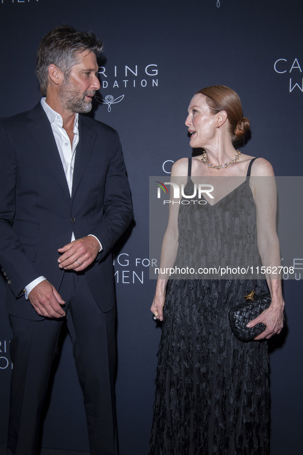 Bart Freundlich and Julianne Moore attend Kering's 3rd Annual Caring for Women Dinner at The Pool in New York, USA, on September 9, 2024. 