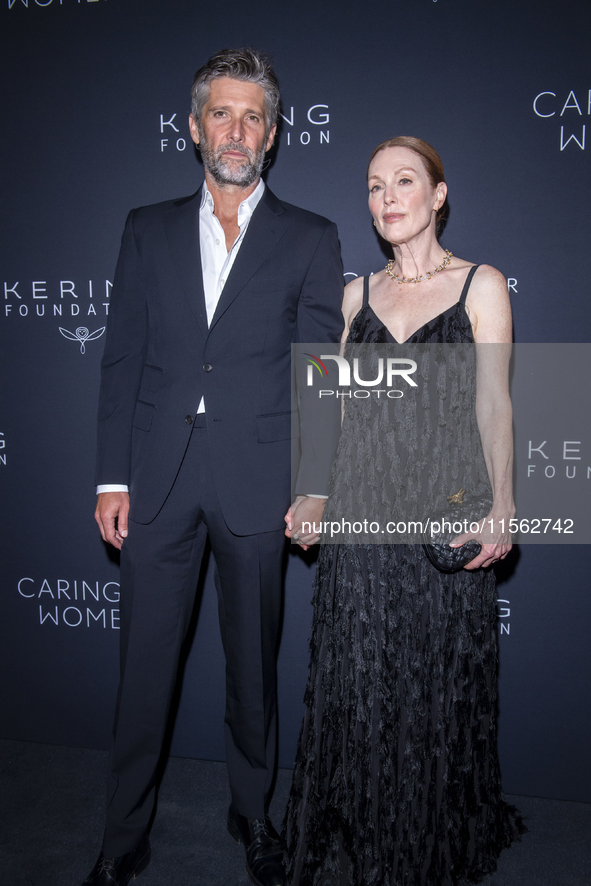 Bart Freundlich and Julianne Moore attend Kering's 3rd Annual Caring for Women Dinner at The Pool in New York, USA, on September 9, 2024. 