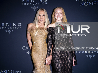 Donatella Versace and Lindsay Lohan attend Kering's 3rd Annual Caring for Women Dinner at The Pool in New York, USA, on September 9, 2024. (