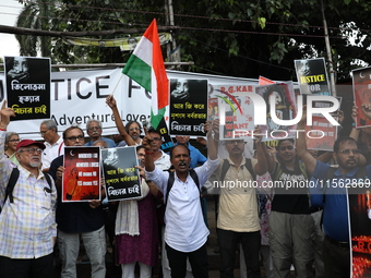 Citizens shout slogans during a protest against the rape and murder of a PGT woman doctor at the government-run R G Kar Medical College and...