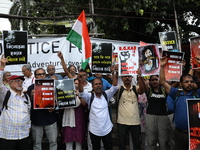 Citizens shout slogans during a protest against the rape and murder of a PGT woman doctor at the government-run R G Kar Medical College and...