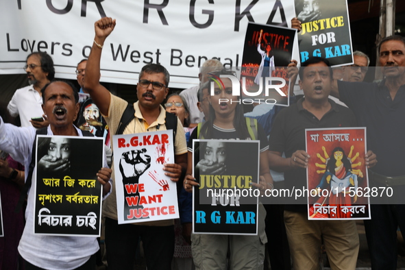 Citizens shout slogans during a protest against the rape and murder of a PGT woman doctor at the government-run R G Kar Medical College and...