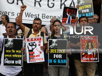 Citizens shout slogans during a protest against the rape and murder of a PGT woman doctor at the government-run R G Kar Medical College and...