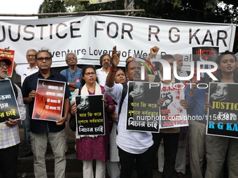 Citizens shout slogans during a protest against the rape and murder of a PGT woman doctor at the government-run R G Kar Medical College and...