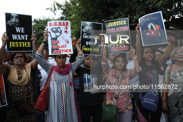 Citizens shout slogans during a protest against the rape and murder of a PGT woman doctor at the government-run R G Kar Medical College and...