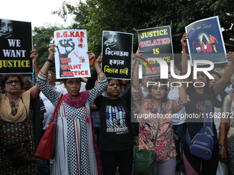 Citizens shout slogans during a protest against the rape and murder of a PGT woman doctor at the government-run R G Kar Medical College and...