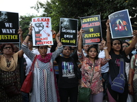 Citizens shout slogans during a protest against the rape and murder of a PGT woman doctor at the government-run R G Kar Medical College and...