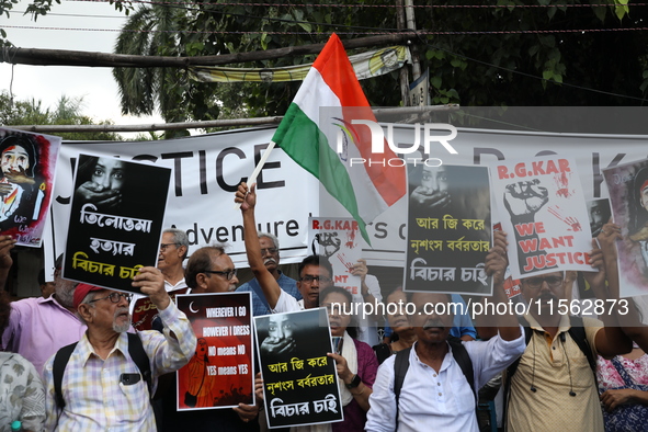 Citizens shout slogans during a protest against the rape and murder of a PGT woman doctor at the government-run R G Kar Medical College and...