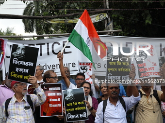 Citizens shout slogans during a protest against the rape and murder of a PGT woman doctor at the government-run R G Kar Medical College and...